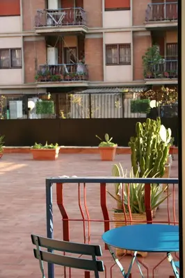 a chair and a table in front of a building at Terrazza Majorana in Rome
