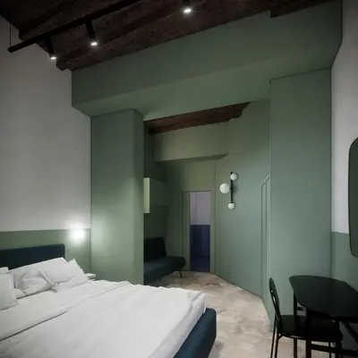 a bedroom with a large white bed and a table at Off in Rome