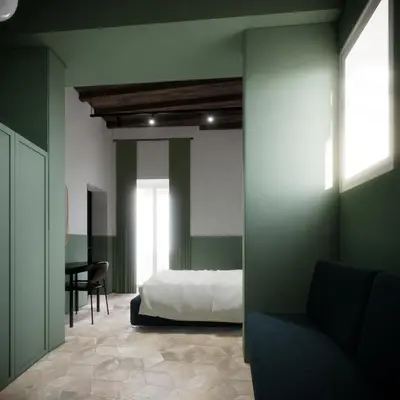 a bedroom with green walls and a bed and a desk at Off in Rome