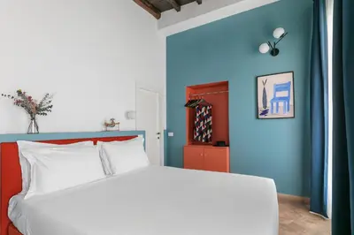 a bedroom with a white bed and blue walls at Off in Rome