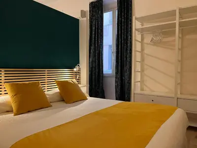 a bedroom with a large bed with yellow pillows at Suite Crescenzio in Laterano in Rome