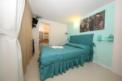 a bedroom with a blue bed in a room at L'Isola di Esme in Rome
