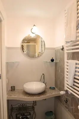 a bathroom with a sink and a mirror at L'Isola di Esme in Rome