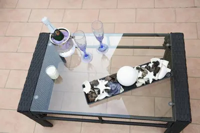 a glass table with wine glasses and figurines on it at L'Isola di Esme in Rome