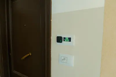 an open door with a clock on the side of a refrigerator at Quiet and cosy central apartment in Rome