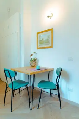 a table with two chairs and a table with a plant on it at Quiet and cosy central apartment in Rome