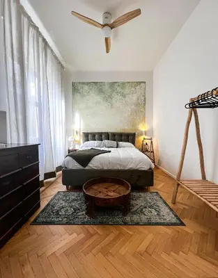 a bedroom with a bed and a painting on the wall at Roma Parioli Suite Green Harmony in Rome