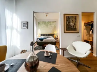 a room with a bed and a table and chairs at Roma Parioli Suite Green Harmony in Rome