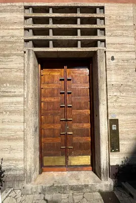 a wooden door on a building with a wooden wall at Roma Parioli Suite Green Harmony in Rome