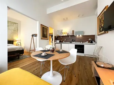 a living room with a table and chairs in a room at Roma Parioli Suite Green Harmony in Rome