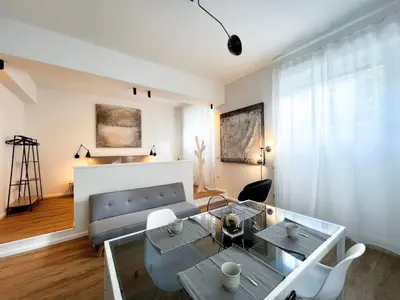 a living room with a couch and a glass table at Roma Parioli - Loft Style in Rome