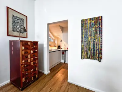 a room with a dresser and a painting on a wall at Roma Parioli - Loft Style in Rome