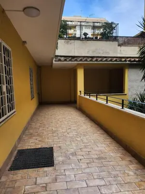 an empty hallway of a building with yellow walls at Al Gondar 7 Libia Roma in Rome