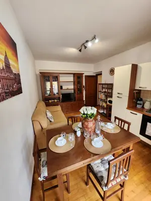 a dining room and living room with a table and chairs at Al Gondar 7 Libia Roma in Rome