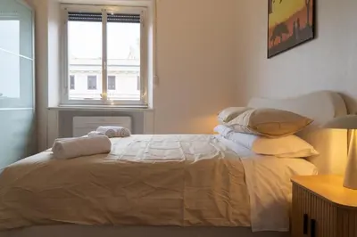 a bedroom with a bed with pillows and a window at La Spezia House in Rome