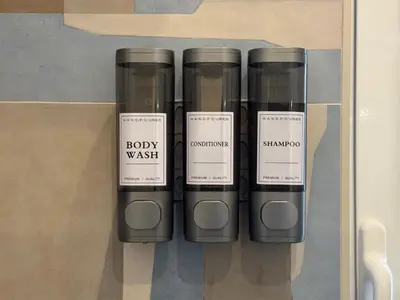 a group of fourbey wash bottles on a shelf at Cozy Place at Gianicolo in Rome