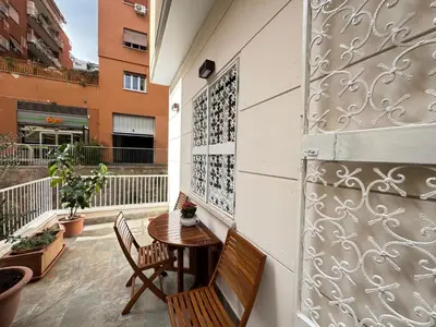 a patio with two chairs and a table on a wall at Cozy Place at Gianicolo in Rome