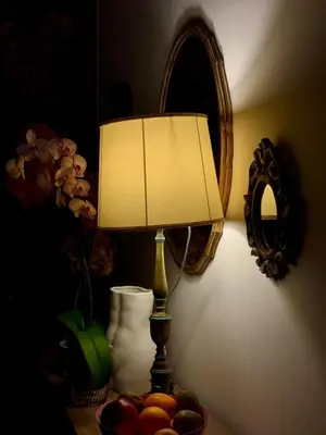 a lamp sitting on a table with a bowl of fruit at Cozy Place at Gianicolo in Rome
