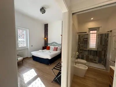 a bedroom with a bed and a shower and a bathroom at Cozy Place at Gianicolo in Rome