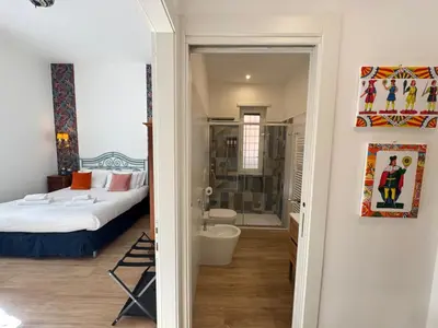 a bedroom with a bed and a bathroom at Cozy Place at Gianicolo in Rome