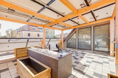 a large room with a roof with windows and a patio at Modern Rooftop Apartment in Rome