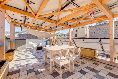 a room with a table and chairs on a balcony at Modern Rooftop Apartment in Rome