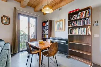 a living room with a table and chairs and a piano at Modern Rooftop Apartment in Rome