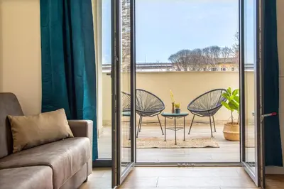 a dining room with a black table and chairs at Urban Oasis with Terrace & free Parking, int11 in Rome