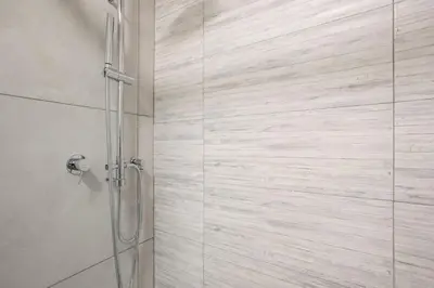 a bathroom with a glass shower with a toilet at Urban Oasis with Terrace & free Parking, int11 in Rome