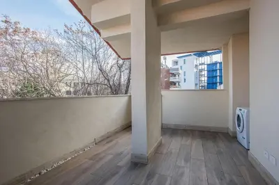 a bed with a book and a plate of bread and a laptop at Urban Oasis with Terrace & free Parking, int11 in Rome
