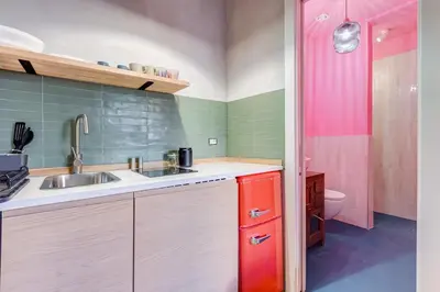 a small kitchen with a sink and a toilet at garden studio apartment in Rome