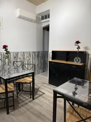 a dining room with two tables and two chairs at FoffoSuite in Rome