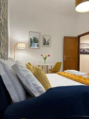 a hotel room with two beds and a table at Cortile di Testaccio in Rome