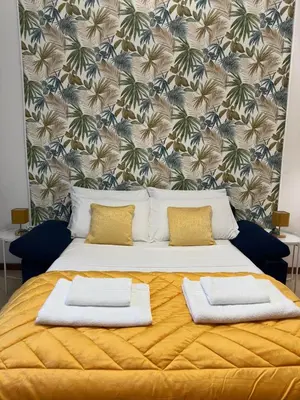 a bedroom with a large bed with two pillows on it at Cortile di Testaccio in Rome