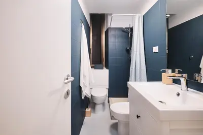 a bathroom with a white sink and a toilet at NEW - La Casetta di Nadia in Rome