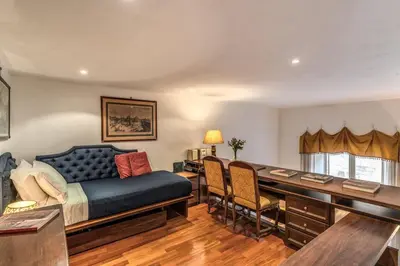 a bedroom with a bed and a desk with chairs at Corso Vittorio top location in Rome
