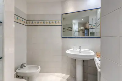 a bathroom with two sinks and a mirror at Corso Vittorio top location in Rome