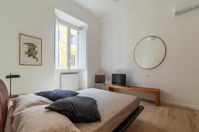 a bedroom with a bed and a mirror on the wall at Bright apartment Acquario Romano in Rome