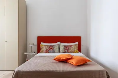 a bedroom with a bed with two pillows at Bright apartment Acquario Romano in Rome