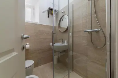 a bathroom with a shower and a toilet and a sink at Bright apartment Acquario Romano in Rome