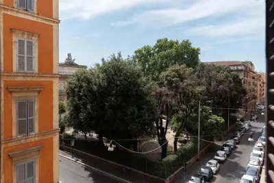 a view of a street with parked cars and trees at Bright apartment Acquario Romano in Rome