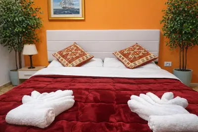 a bed with two white mitts on top of it at NEXT Palace in Rome
