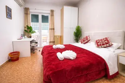 a bedroom with a large red bed with towels on it at NEXT Palace in Rome