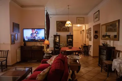 a living room with a couch and a tv at Antonietta's Home in Rome