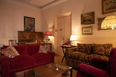 a living room with a red couch and a table at Antonietta's Home in Rome