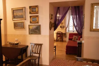 a living room with a table and a dining room at Antonietta's Home in Rome