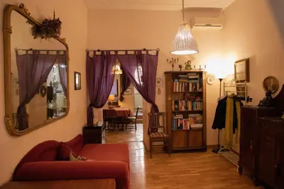 a living room with a couch and a mirror at Antonietta's Home in Rome