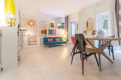 a living room with a table and a blue couch at Gianicolo Secret Garden Suite in Rome