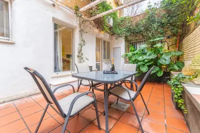 a table and chairs on a patio with plants at Gianicolo Secret Garden Suite in Rome