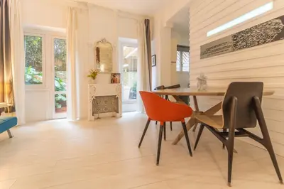 a dining room with a table and chairs at Gianicolo Secret Garden Suite in Rome